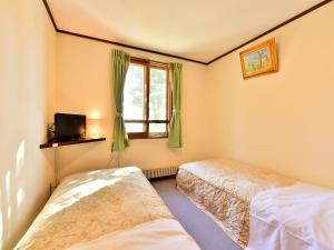 Postel nebo postele na pokoji v ubytování Kurumayama Kogen Guesthouse Urara