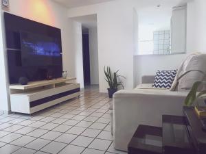 a living room with a large flat screen tv at BOA VIAGEM 2 quartos 100 m da praia até 5 pessoas in Recife