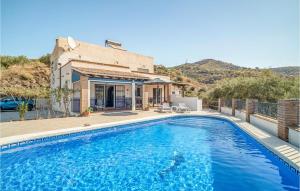 a swimming pool in front of a house at 4 Bedroom Beautiful Home In Arenas in Arenas