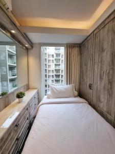 a bedroom with a large bed and a window at New! Luxury Landmark Residence Apartment 2+1BR 96m in Bandung