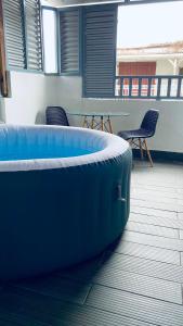 a large blue tub sitting on the floor of a room at Cosy suite centre ville avec bain à remous in Pointe-à-Pitre
