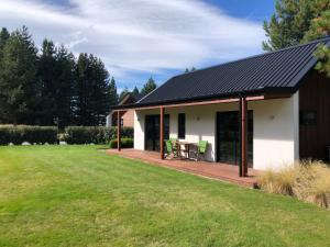 a house with a patio and a grass yard at Twizel - Arohanui Cottage in Twizel