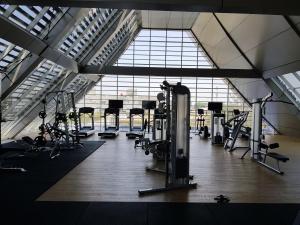 a gym with many treadmills and cardio machines at New! Luxury Landmark Residence Apartment 2+1BR 96m in Bandung