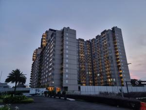a large apartment building with lights on at New! Luxury Landmark Residence Apartment 2+1BR 96m in Bandung