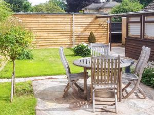 a wooden table and chairs in a yard at East View in Shouldham