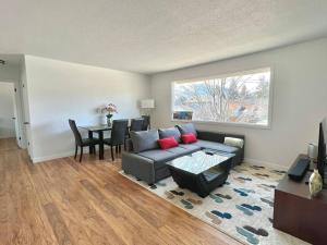 a living room with a couch and a table at Central Penticton. Alongside KVR Trail. Freshly Renovated. Pet Friendly. in Penticton
