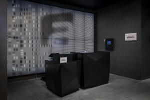 a room with black and white walls and a person at Aloft Orlando Lake Buena Vista in Orlando