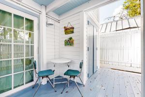 a patio with two chairs and a table on a porch at Seagrass Suite in Key West