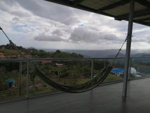 a hammock on a balcony with a view of the mountains at Casa Blanca de Chicá in Chicá