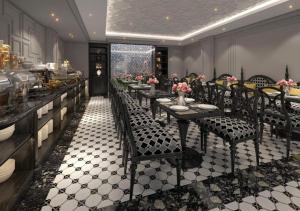 a restaurant with long tables and chairs with flowers at Le Grand Hanoi Hotel - 18 Hàng Quạt by Bay Luxury in Hanoi