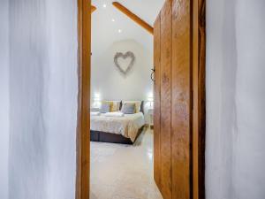 ein Schlafzimmer mit einem Bett mit einem Herzschild an der Wand in der Unterkunft The Old Granary in Cumberworth