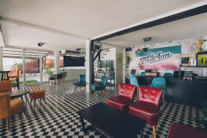 a waiting room with chairs and tables in a restaurant at Chill Inn Lamai Hostel & Beach Cafe in Koh Samui