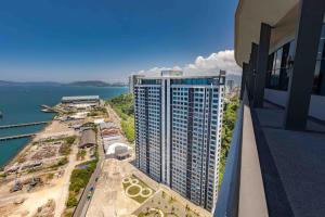 arial view of a tall building with a view of the ocean at HayBay Jesselton Quay Deluxe Seaview Suite 海景观 in Kota Kinabalu
