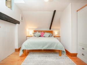 a bedroom with a bed and two night stands at The Coach House in South Zeal