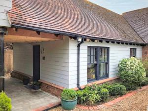 a white house with a brown roof at Little Lodge in West Mersea