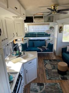a kitchen and living room of an rv at Rustic Farm meadow stay in Temecula