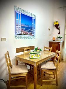 a dining room with a table and chairs and a window at Street of Naples Apartment in Naples