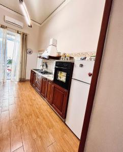 a kitchen with a refrigerator and a stove at Street of Naples Apartment in Naples