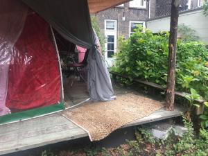 a person standing on a porch in a tent at Vintage Dome Igloo tent, Lange Haven Schiedam in Schiedam