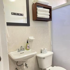 a bathroom with a white toilet and a sink at Habitacion Privada Ejecutiva Minisplit Amenidades 2 in Castillo Teresa +43 photos