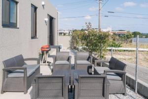 een groep stoelen en een tafel op een patio bij プライベートハウス ぅーじ家 in Hanagusuku