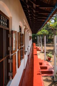 an empty corridor of a building with an orange carpet at Kuttanad Kayak Club by Lexstays in Alleppey
