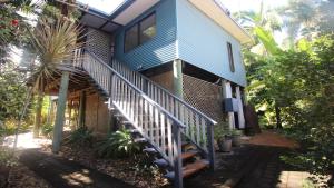 a blue house with stairs leading up to it at Magnetic Mango Escape in Horseshoe Bay