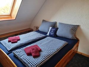 two beds in a small room with red towels on them at Ferienwohnungen Buschsand 15 Friedrichskoog-Spitze in Friedrichskoog