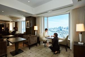 two people sitting at a table in a hotel room at InterContinental Tokyo Bay by IHG in Tokyo