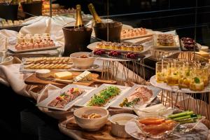 a buffet with many different types of food on plates at InterContinental Tokyo Bay by IHG in Tokyo