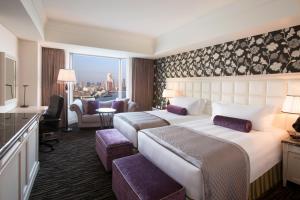 a hotel room with two beds and a large window at InterContinental Tokyo Bay by IHG in Tokyo