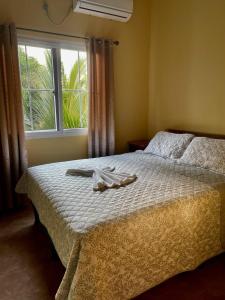 a bedroom with a bed with a towel on it at Hotel y Restaurante Virgen de Fátima in La Ceiba