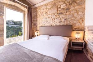 Postel nebo postele na pokoji v ubytování San Giorgio Palace Hotel Ragusa Ibla