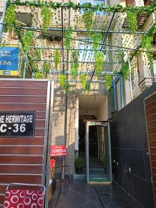 an entrance to a building with a sign on it at The Hermitage by The Cosy Hotels Near Lotus Temple in New Delhi