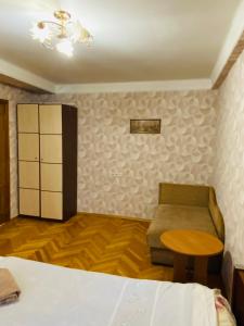 キーウにあるKvartira vozle metro Darnitcaのベッドルーム1室(ベッド1台、椅子、テーブル付)
