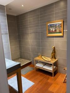 a bathroom with a shower with a table in it at Le Patio Père Pigne Guestroom in Perpignan