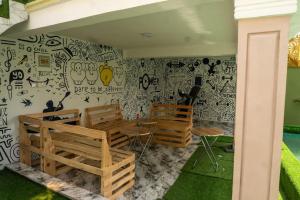 a room with two chairs and a wall with graffiti at Elegant 1-Bed With Unlimited Internet + 24hrs POWER in Lagos