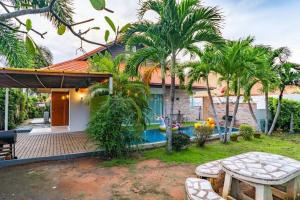 a house with a backyard with a swimming pool at the time poolvilla3 in Jomtien Beach