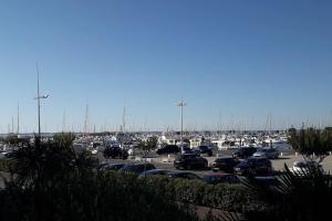 Un parking avec beaucoup de voitures et de bateaux dans l'établissement Appartement sur le port d'Arcachon proche plages, à Arcachon