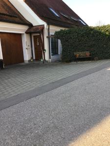 a house with a bench in front of a building at Ferienwohnung Heigemeir in Ehekirchen
