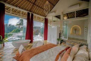 a bedroom with a large bed and a bath tub at Villa Cella Bella Ubud in Ubud