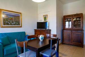 a dining room with a table and a couch at Casa Rita in Castiglione della Pescaia
