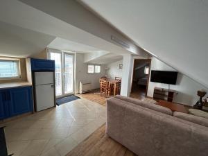 a living room with a couch and a kitchen at Villa Gloria 2 in Dubrovnik