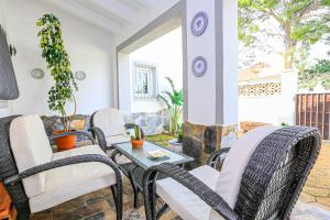 a patio with wicker chairs and a table at Villa Albada - ONLY FAMILIES in Miami Platja