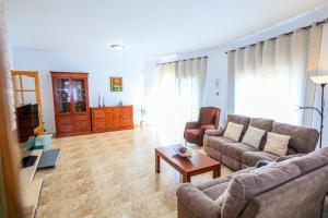 a living room with a couch and a coffee table at Villa Albada - ONLY FAMILIES in Miami Platja