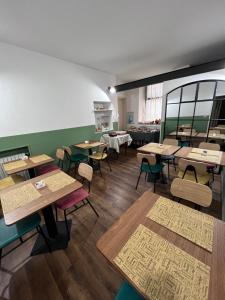 an empty restaurant with tables and chairs and a kitchen at Hotel Brenta in Parma