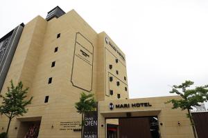 a building with a sign on the front of it at Mari Hotel in Cheongju