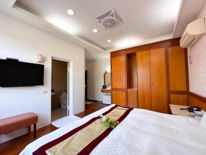 Li Quan Hot Spring Resort tesisinde bir odada yatak veya yataklar