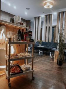 a living room with a table with food and drinks at Apartament & Spa Rosa in Istebna