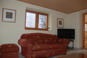 a living room with a couch and a flat screen tv at Domček pod Starým mestom in Banská Štiavnica